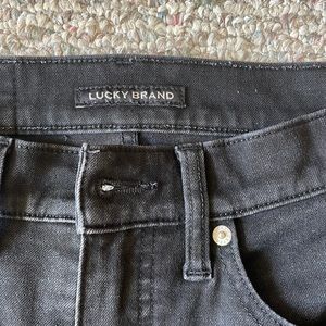 High rise, skinny black jeans with cut out in knee by LUCKY BRAND
